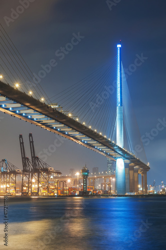 Cargo port and bridge in Hong Kong city at night