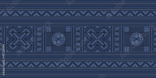 Embroidered seamless pattern. Vector illustration. Midnight and light blue lines and dots on indigo blue background, hill tribe inspired. Vector illustration. For printing on fabric or wallpaper.