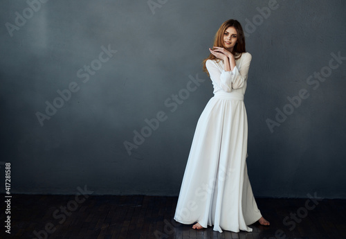 attractive woman in white dress glamor gray background
