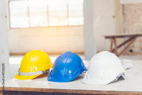 Construction hard hat safety tools equipment for workers in construction site for engineering protection head standard. Many hard hat helmet on row with copy space. Engineering Construction Concept