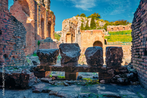 Sunny spring scene of ancient Greco-Roman theater, Taormina town, Sicily, Itale, Europe. Traveling concept background. photo