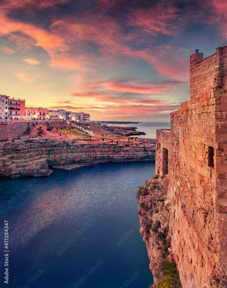 Сharm of the ancient cities of Europe. Fantastic spring cityscape of Polignano a Mare town, Puglia region, Italy, Europe. Stunning evening seascape of Adriatic sea. Traveling concept background.