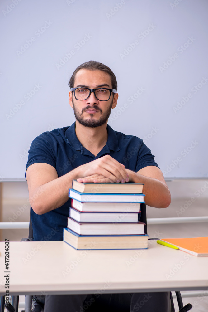 Young male handicapped student in the classroom