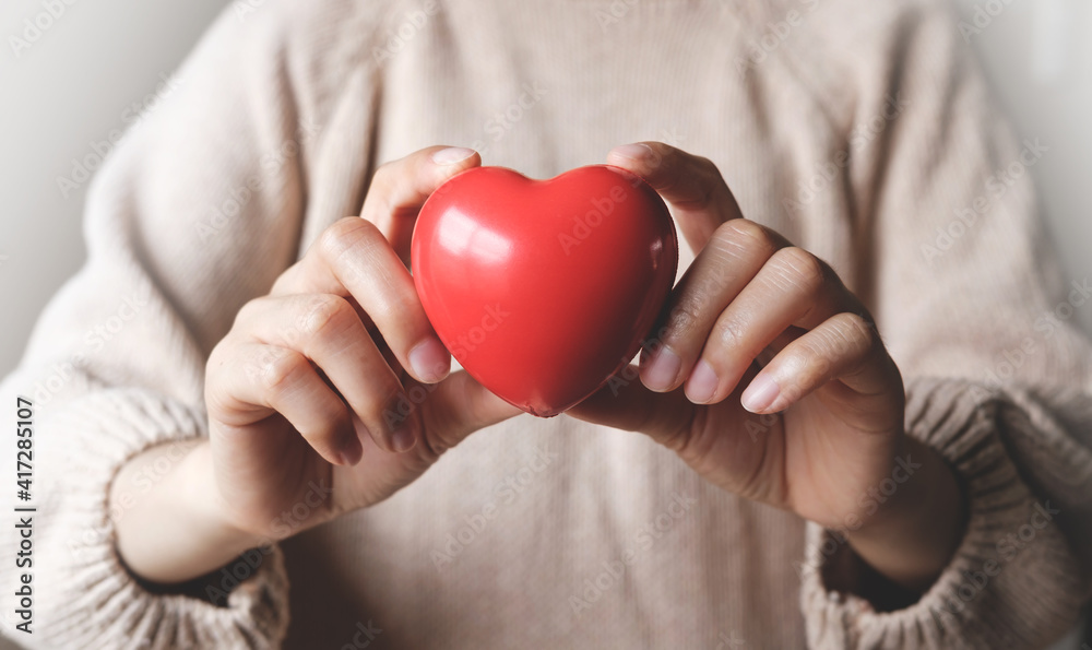 Red hearts with loving and caring adults. Symbol of support that expresses love valentine day and world heart day, heart health concept Red hearts with loving and caring adults. Symbol of support that expresses love valentine day and world heart day, heart health concept