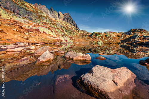 Alps mountain range feflected in calm water of Chesery lake/Lac De Chesery, Chamonix location. Amazing outdoor scene of Vallon de Berard Nature Preserve, Graian Alps, France, Europe.