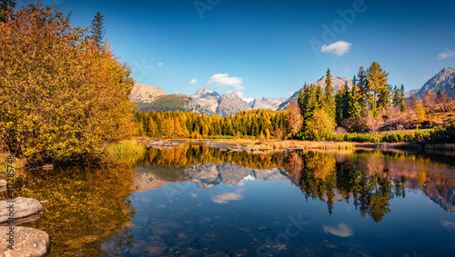 Beautiful autumn scenery. Calm morning view of Strbske pleso lake. Spectacular outdoor scene of High Tatra National Park, Slovakia, Europe. Beauty of nature concept background.