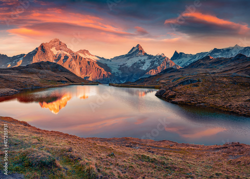 Fototapeta Naklejka Na Ścianę i Meble -  Astonishing morning view of Bachalp lake (Bachalpsee), Switzerland. Impressive autumn sunrise in Swiss Alps, Grindelwald, Bernese Oberland, Europe. Beauty of nature concept background.