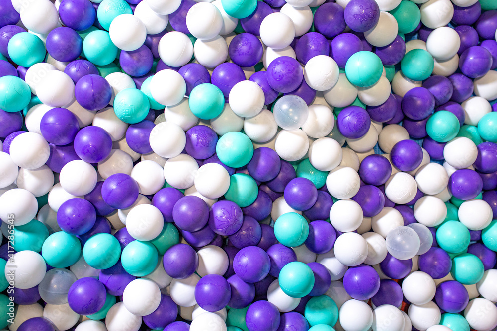 beautiful background with colored plastic balls in the playroom pool. Pool for fun with white and blue balls beautiful background with colored plastic balls in the playroom pool. Pool for fun with white and blue balls