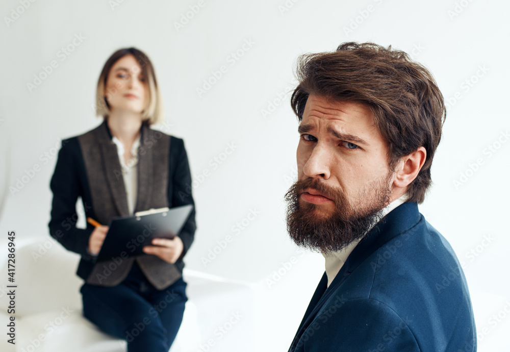and emotional man at job interview and business woman in suit in the background and emotional man at job interview and business woman in suit in the background