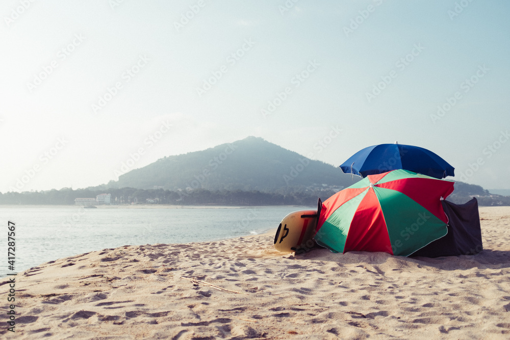 parasol on beach in front of coastline