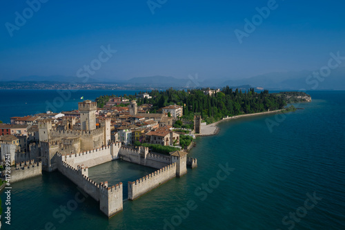 Wallpaper Mural Amazing view to the old bridge and harbor of Sirmione. View by Drone. Rocca Scaligera Castle in Sirmione. Aerial view on Sirmione sul Garda. Italy, Lombardy. Torontodigital.ca