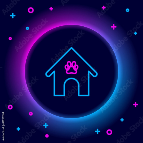 Glowing neon line Dog house and paw print pet icon isolated on black background. Dog kennel. Colorful outline concept. Vector.