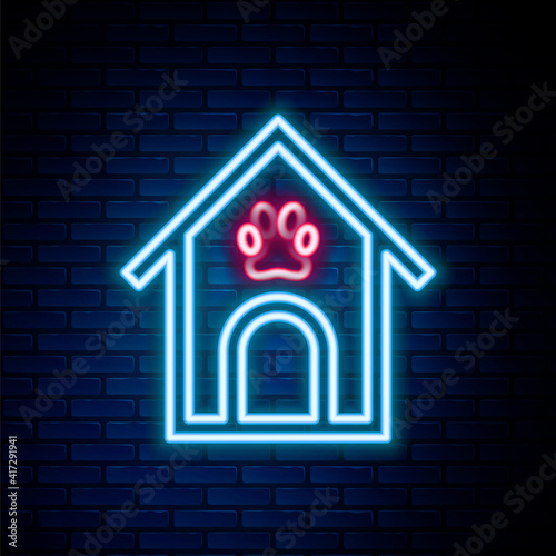 Glowing neon line Dog house and paw print pet icon isolated on brick wall background. Dog kennel. Colorful outline concept. Vector.