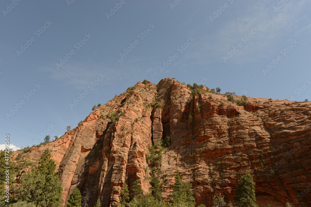 Scenic view of the mountains, cliffs and trees at Zion National Park on a sunny day Scenic view of the mountains, cliffs and trees at Zion National Park on a sunny day