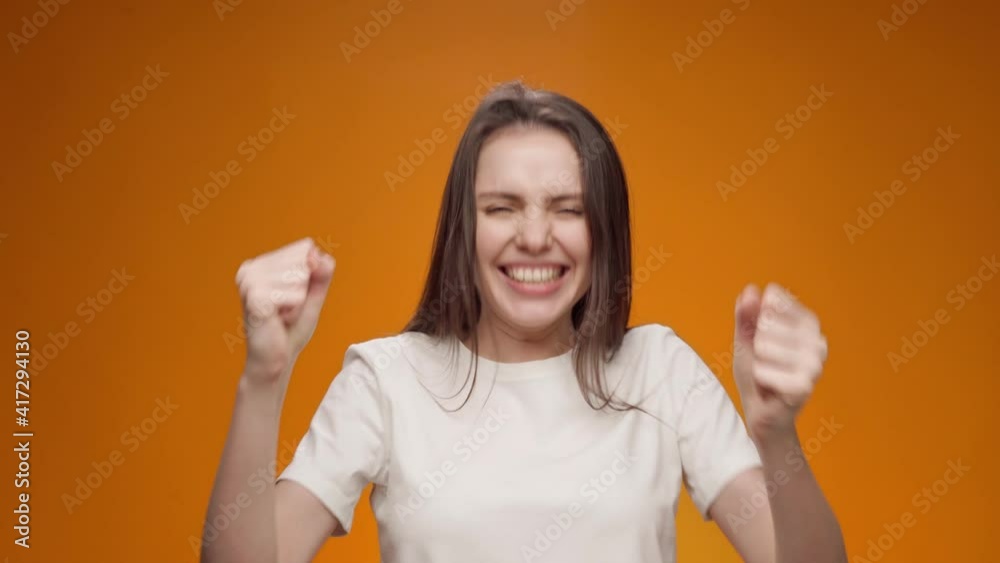 Happy woman celebrating success, joyful dance, portrait Happy woman celebrating success, joyful dance, portrait