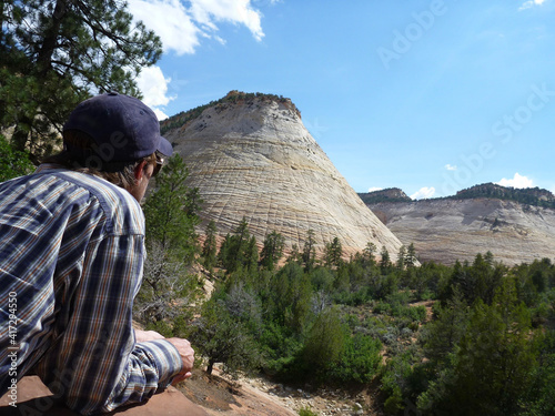 A hiker taking in the view of the mountains at Zion National Park in Utah