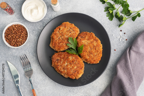 Photos Buckwheat cutlets with cheese and parsley on a plate