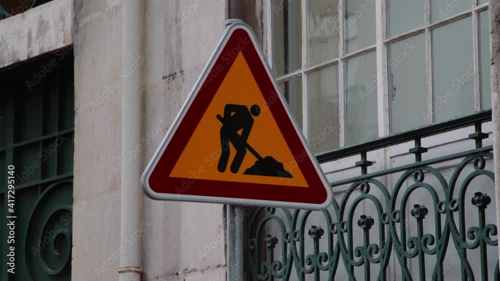 Portuguese Construction Traffic Sign with building behind Portuguese Construction Traffic Sign with building behind