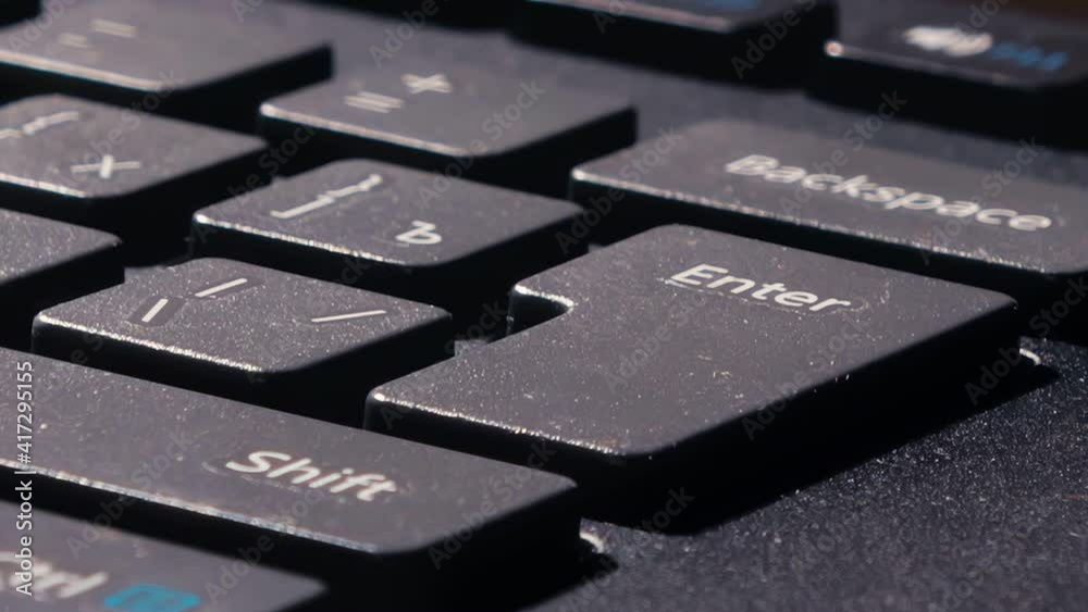 the finger presses the enter key several times. various pressing of the enter key. single clicks.