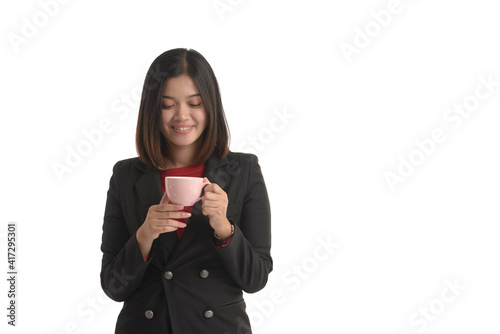 Asian business woman is holding a cup of coffee and looking it. On white Background.