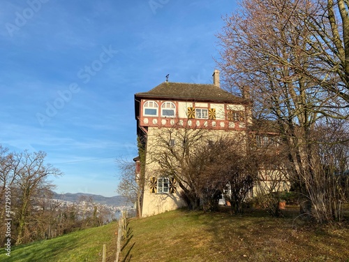 The old traditional Gugger House building on the hill of the Au Peninsula in Lake Zurich (Zürichsee oder Zuerichsee), Wädenswil (Waedenswil) - Canton of Zürich (Zuerich), Switzerland / Schweiz photo