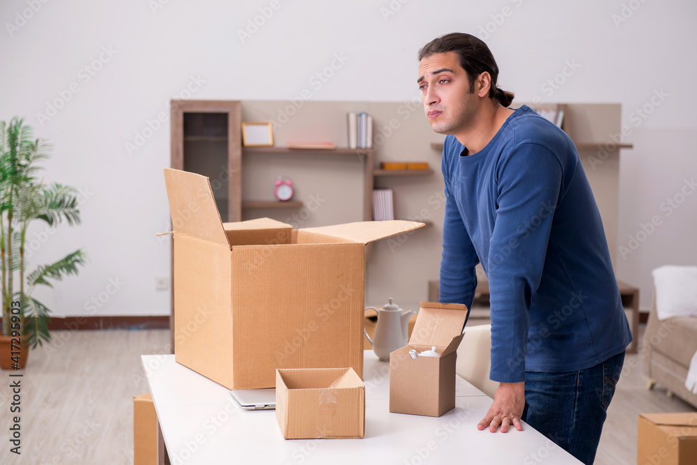 Young man moving to new flat Young man moving to new flat