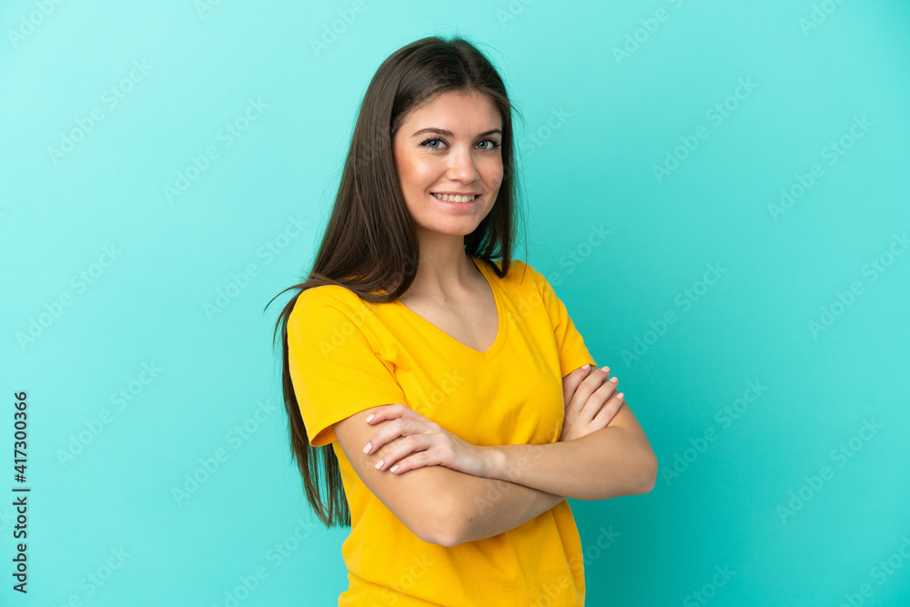 Young caucasian woman isolated on blue background with arms crossed and looking forward Young caucasian woman isolated on blue background with arms crossed and looking forward