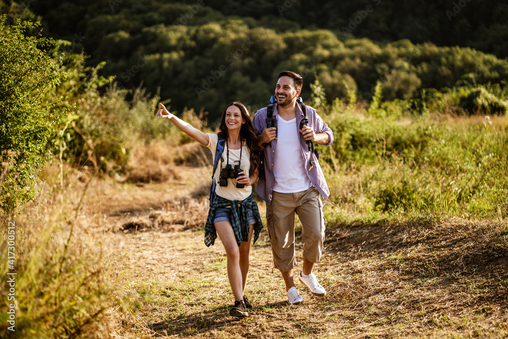 Fototapeta premium Happy couple is hiking in mountain.