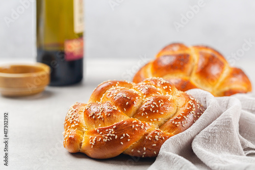 Cuadro en lienzo Homemade challah bread rolled into circular shape with a cover, contains eggs, olive oil, water, yeast, topped with sesame