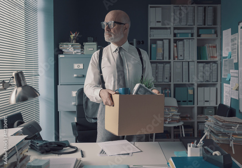 Businessman packing and leaving the office