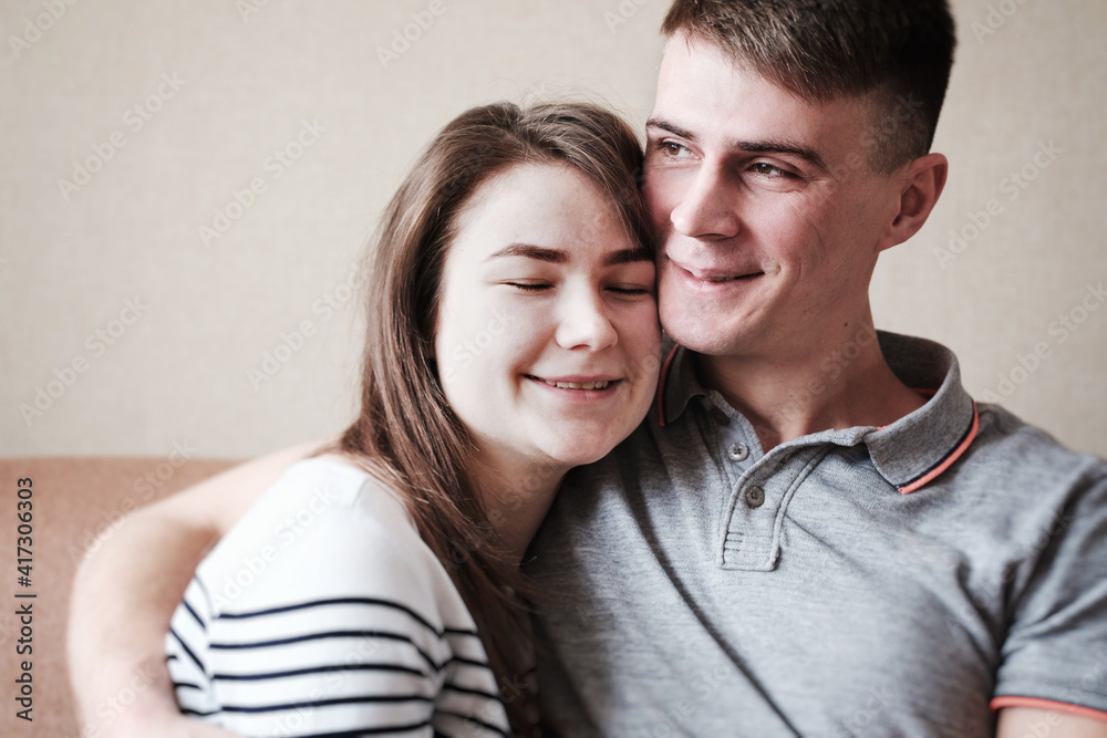 An attractive woman in a hugged man lies on his shoulder with closed eyes - The concept of love, support and tenderness - Relationship in love - Quarantine lifestyle