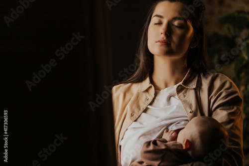 Natural nutrition. Mother breastfeeding her cute little baby at home, closeup portrait photo