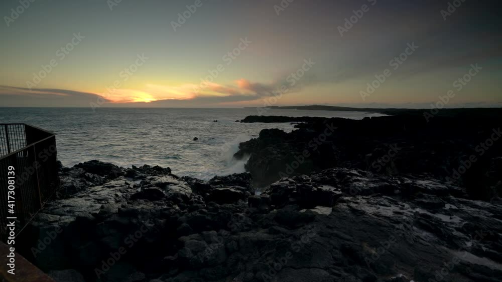 Waves Crashing On A Rocky Coast At Sunset - wide shot Waves Crashing On A Rocky Coast At Sunset - wide shot
