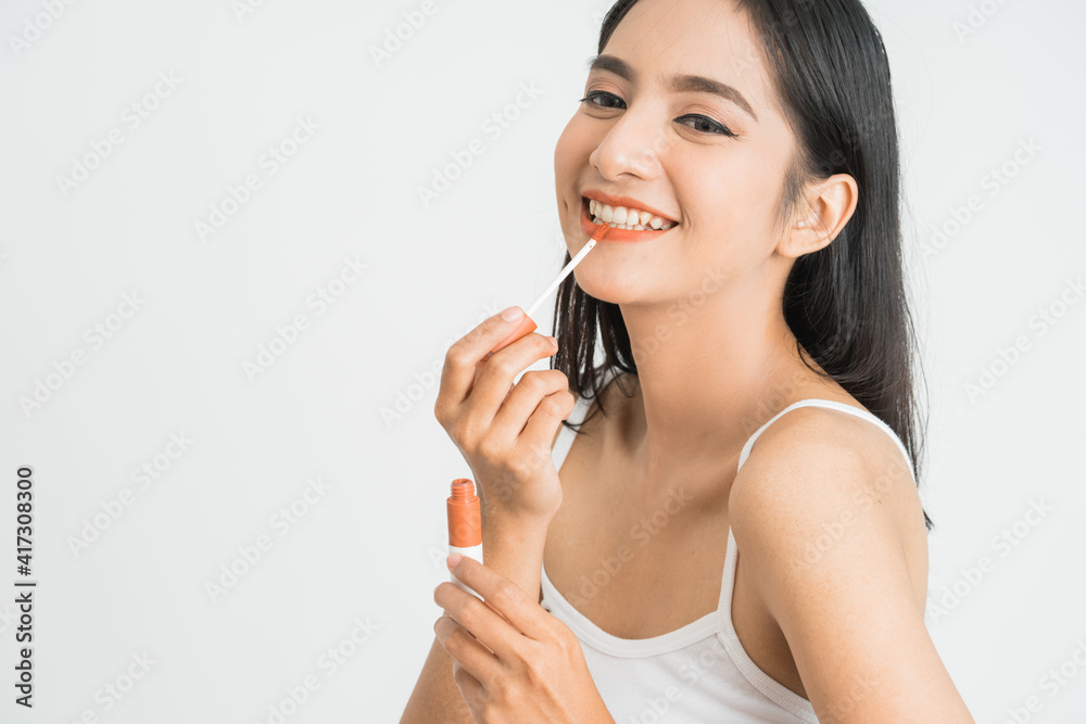 beauty face of asian woman. portrait of female applying lipstick on her face close up beauty face of asian woman. portrait of female applying lipstick on her face close up