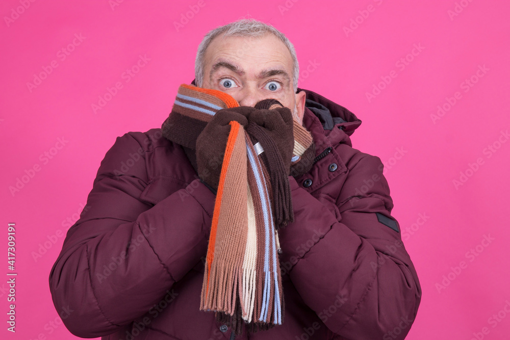 mature man bundling up with scarf and jacket mature man bundling up with scarf and jacket