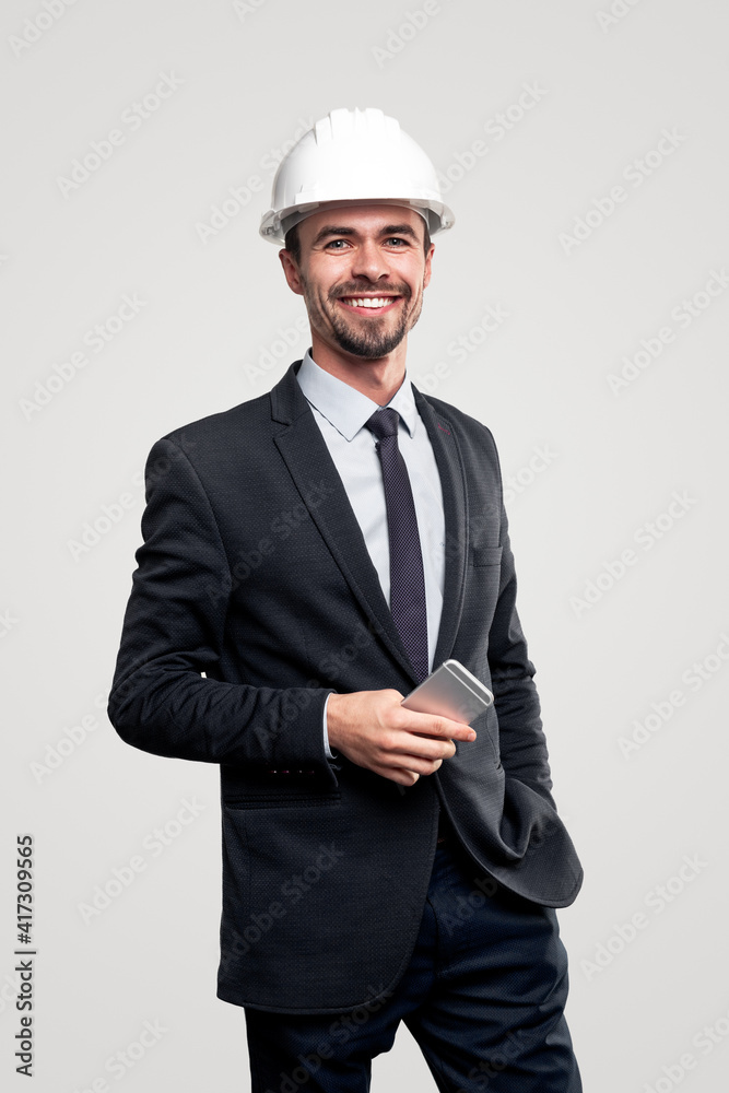 Confident architect with smartphone looking at camera Confident architect with smartphone looking at camera