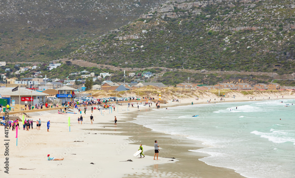 Swimmers frolicking in the shallow waves of Fish Hoek beach