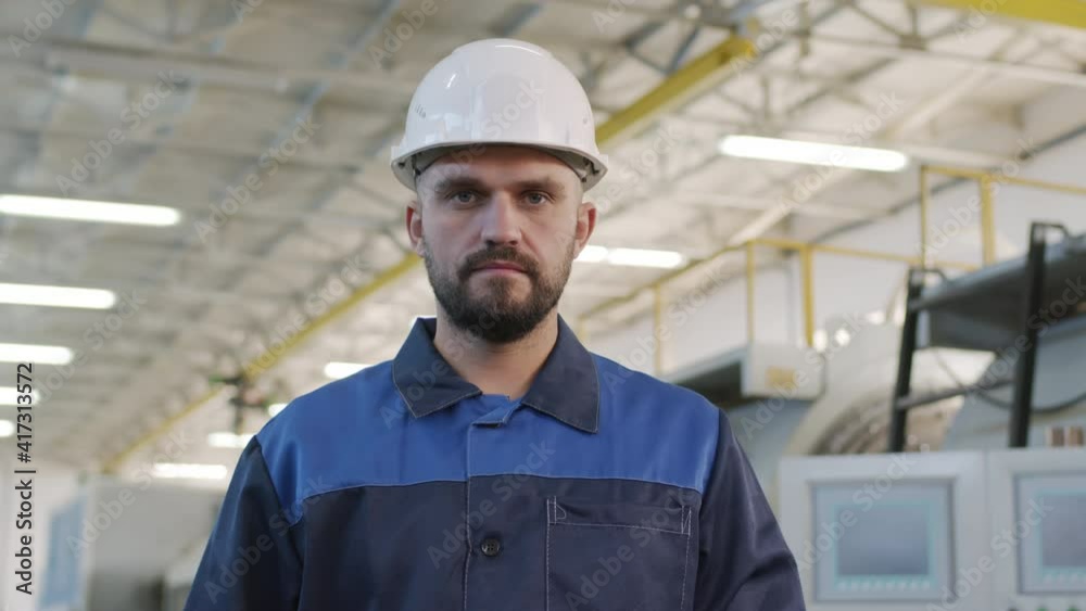 Portrait shot of serious plant foreman in uniform and hard hat posing for camera in workplace Portrait shot of serious plant foreman in uniform and hard hat posing for camera in workplace