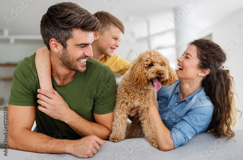 Portrait of happy family with a dog having fun together at home.
