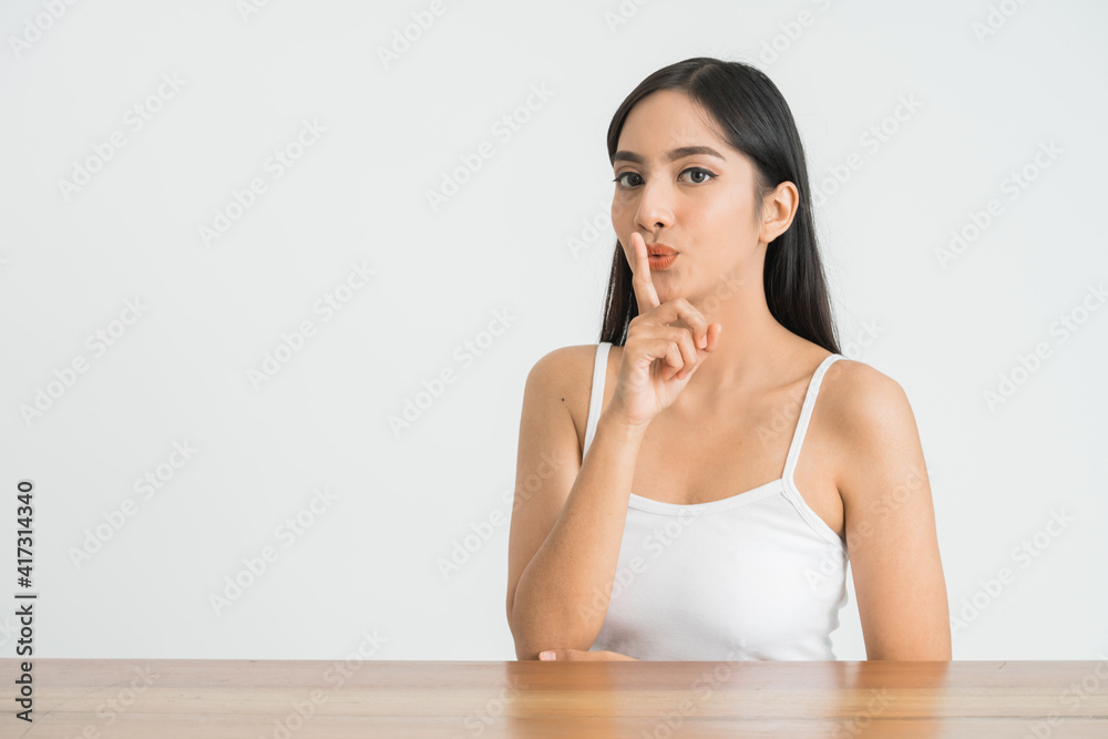closeup young asian woman face with quiet gesture closeup young asian woman face with quiet gesture