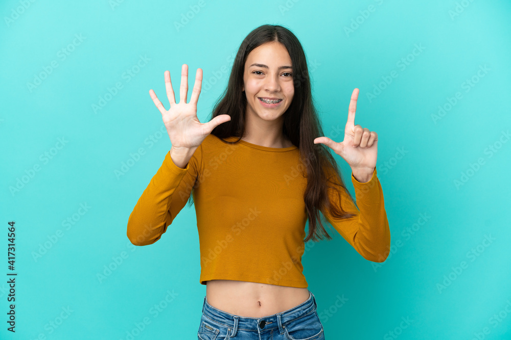 Young French woman isolated on blue background counting seven with fingers Young French woman isolated on blue background counting seven with fingers