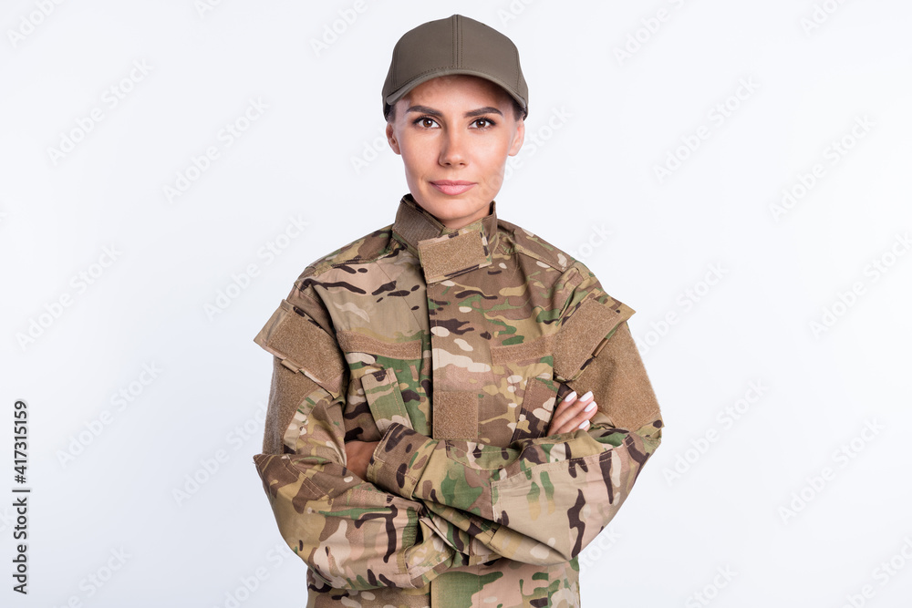 Photo of young woman confident soldier army officer crossed hands uniform isolated over white color background Photo of young woman confident soldier army officer crossed hands uniform isolated over white color background