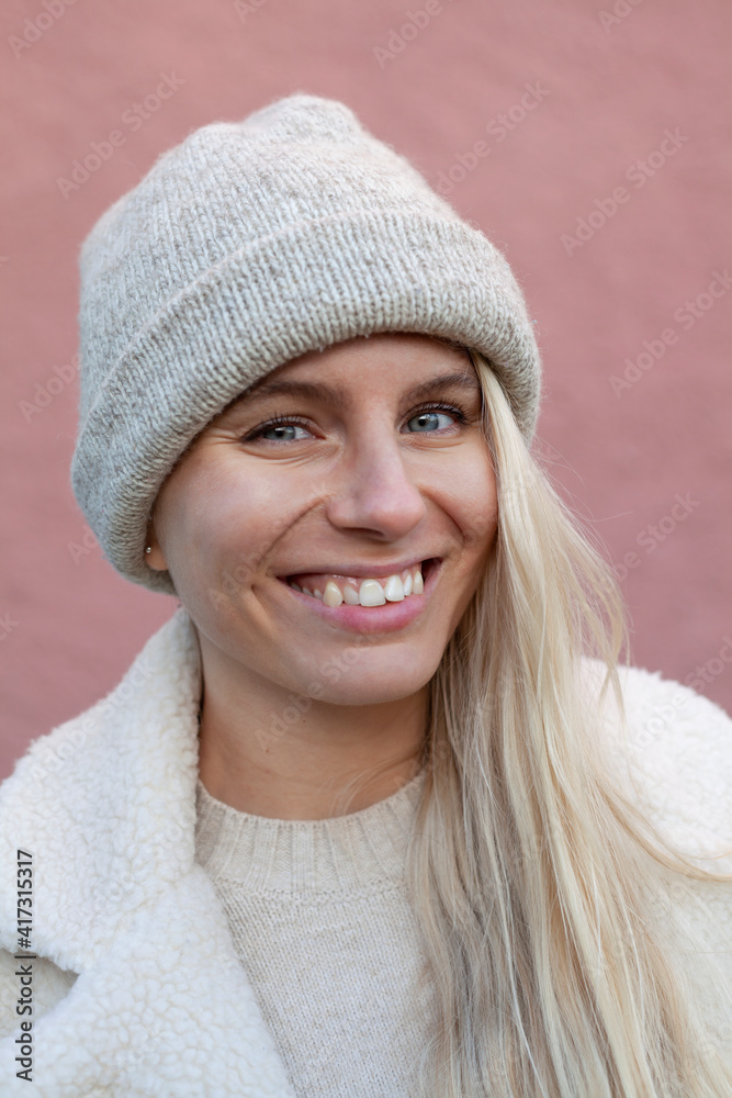 Portrait of smiling young woman in knit hat Portrait of smiling young woman in knit hat