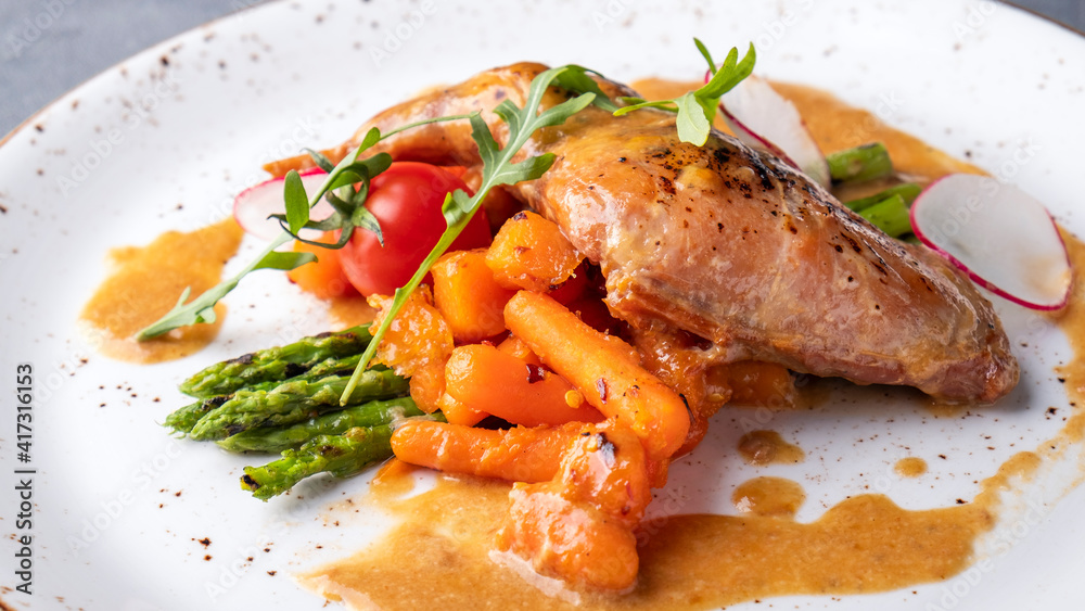 Stewed rabbit leg with vegetables. Closeup Stewed rabbit leg with vegetables. Closeup
