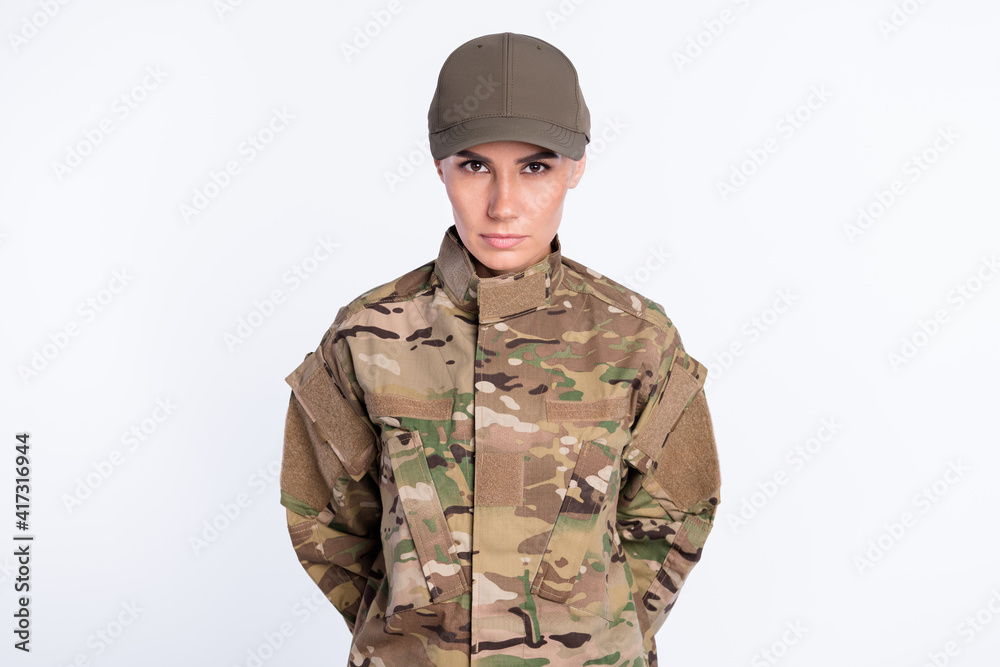 Photo of confident young military girl look attentively camera calm face isolated on white color background Photo of confident young military girl look attentively camera calm face isolated on white color background