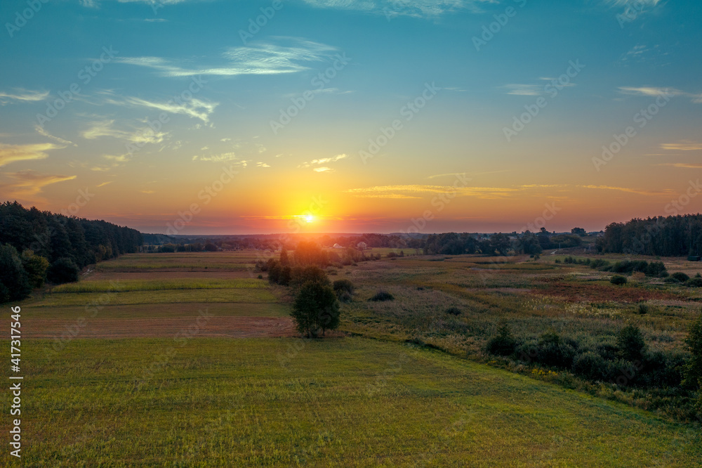 Sunset in the countryside. Rural landscape in spring. Aerial view