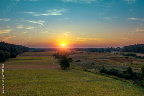 Sunset in the countryside. Rural landscape in spring. Aerial view