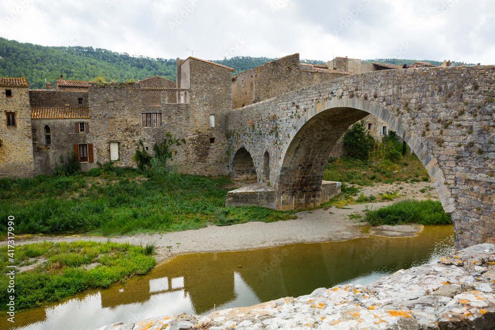 View of medieval stone arched bridge of Benedictine Abbey Sainte-Marie d'Orbieu in Lagrasse