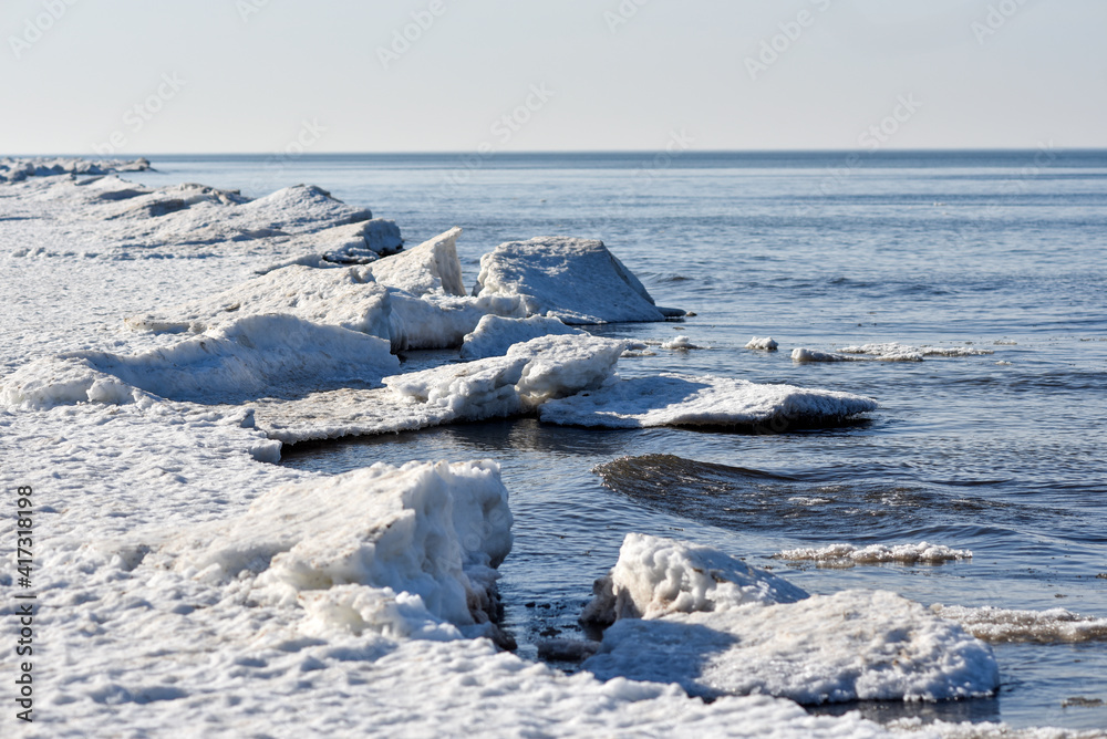 Winter seaside landscape, melting ice and snow on the beach. Winter seaside landscape, melting ice and snow on the beach.