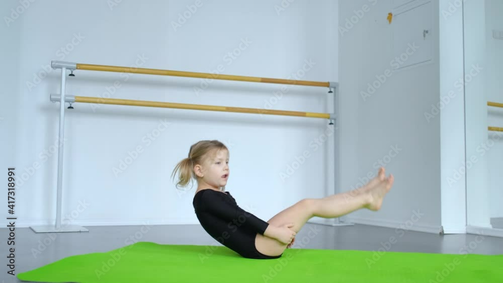 little girl swinging on her back for a lesson in the hall little girl swinging on her back for a lesson in the hall